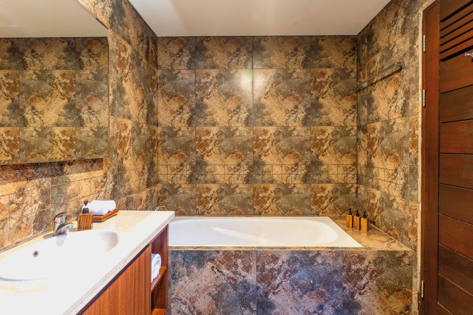 Separate tub and shower, rainfall showerhead, free toiletries