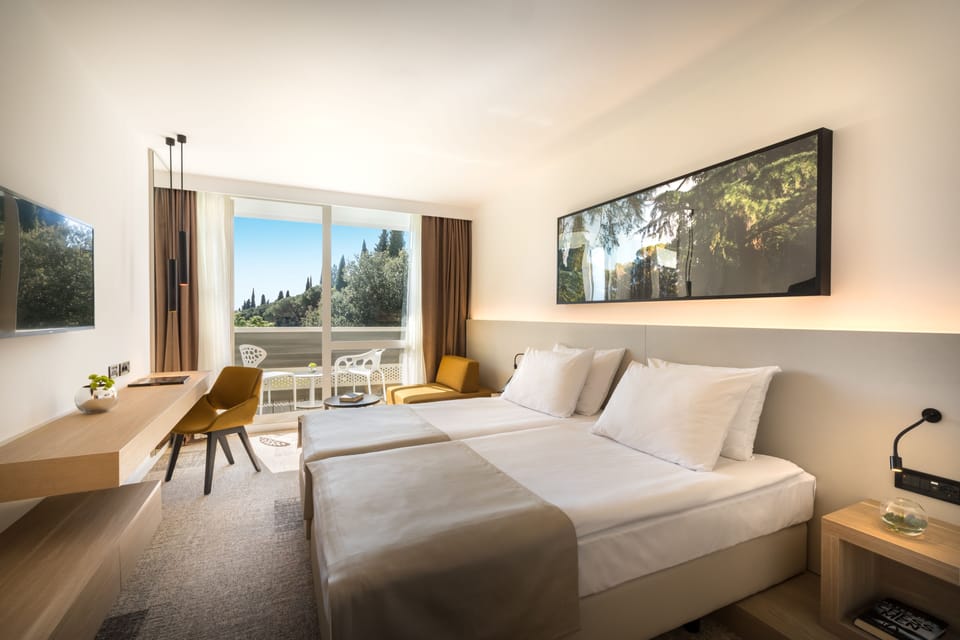 Superior Triple Room | Minibar, in-room safe, desk, blackout drapes