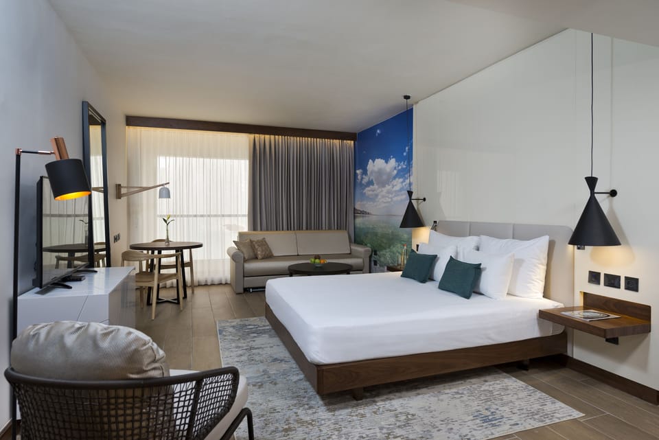 Family Room, Pool View (Moav) | Minibar, in-room safe, desk, iron/ironing board