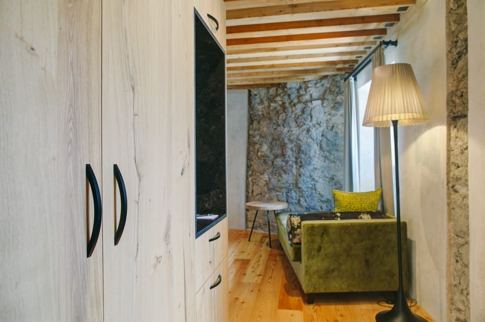 Deluxe Double Room | Living area | Flat-screen TV, first-run movies, heated floors