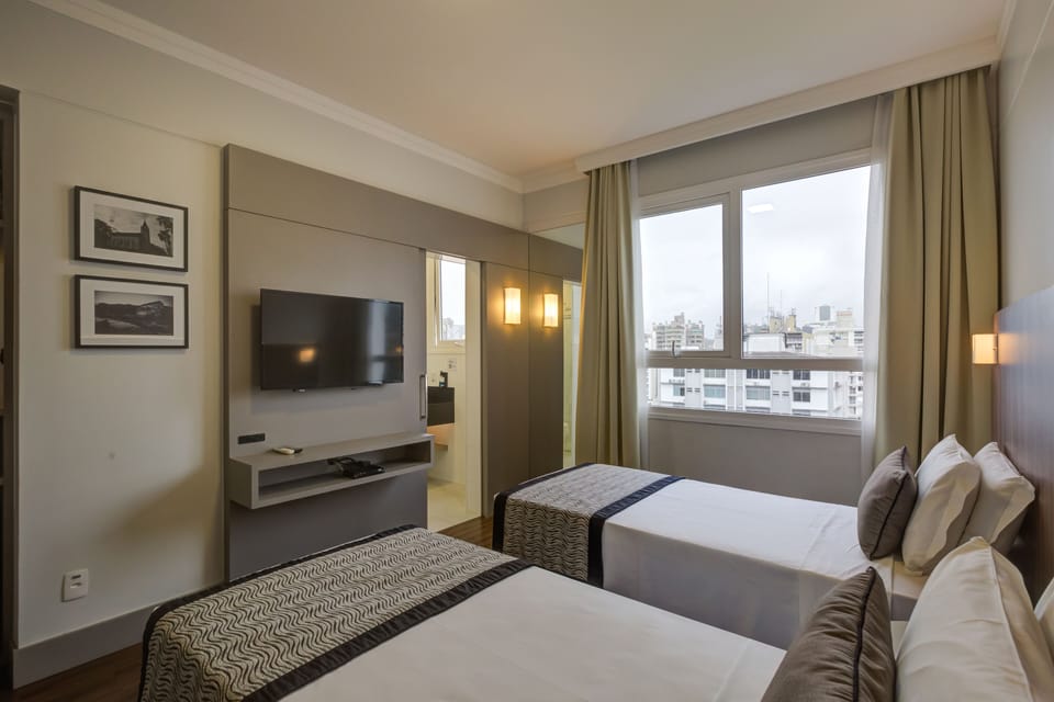 Deluxe Twin Room, 2 Twin Beds | In-room safe, desk, laptop workspace, blackout drapes