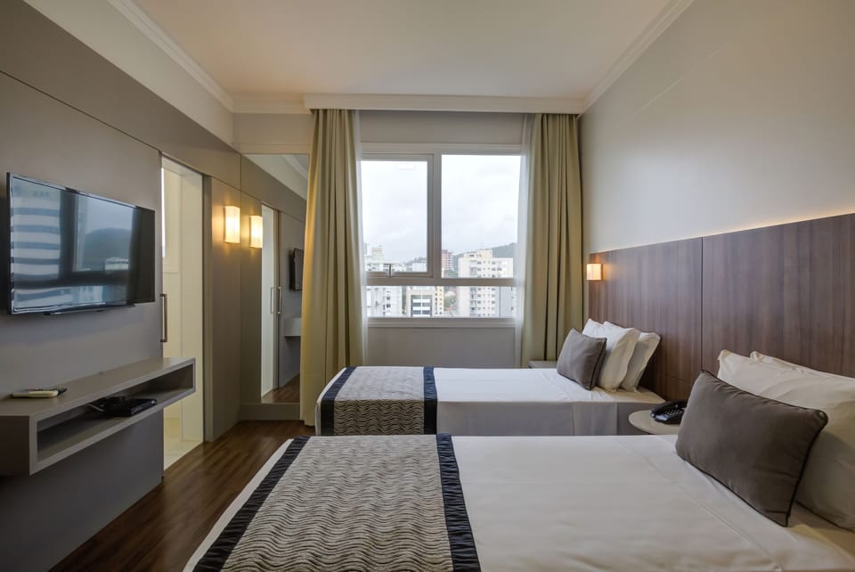 Deluxe Twin Room, 2 Twin Beds | In-room safe, desk, laptop workspace, blackout drapes