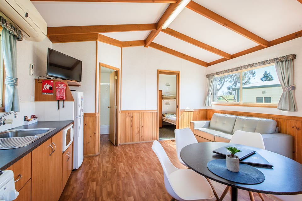 Standard 2 Bedroom Cabin | Living area | Flat-screen TV