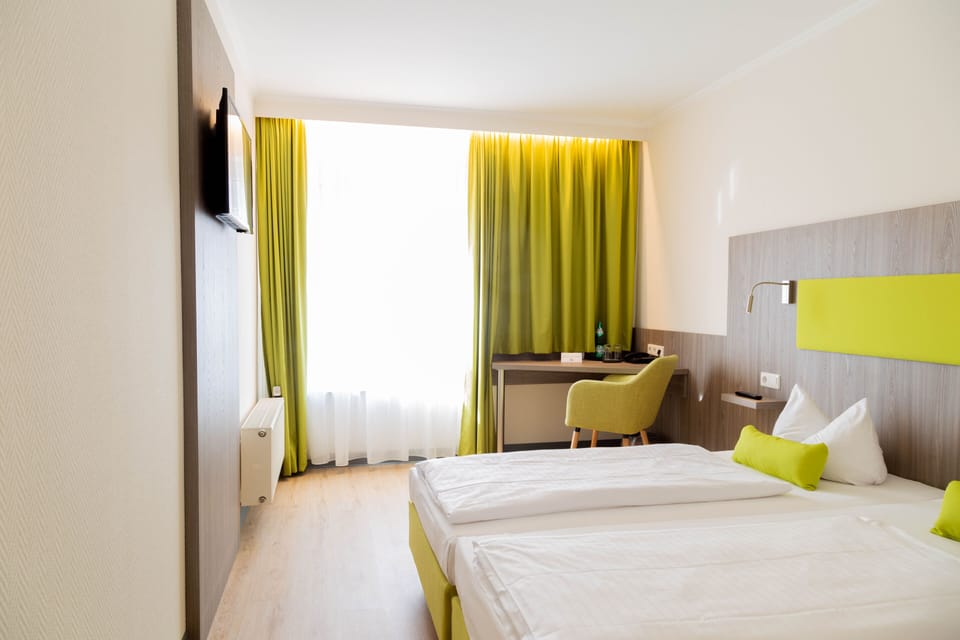 Hypo-allergenic bedding, desk, laptop workspace, blackout drapes