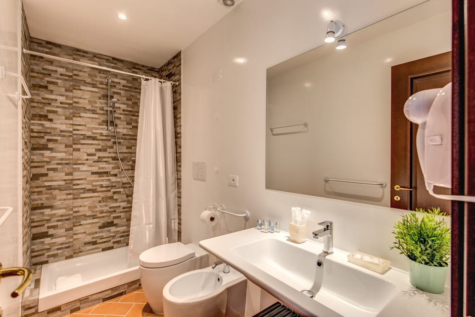 Deluxe Quadruple Room | Bathroom | Shower, hair dryer, bidet, towels