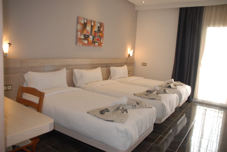 Standard Triple Room | Premium bedding, in-room safe, desk, blackout drapes