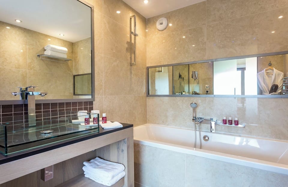 Family Room | Bathroom | Bathtub, designer toiletries, hair dryer, bathrobes