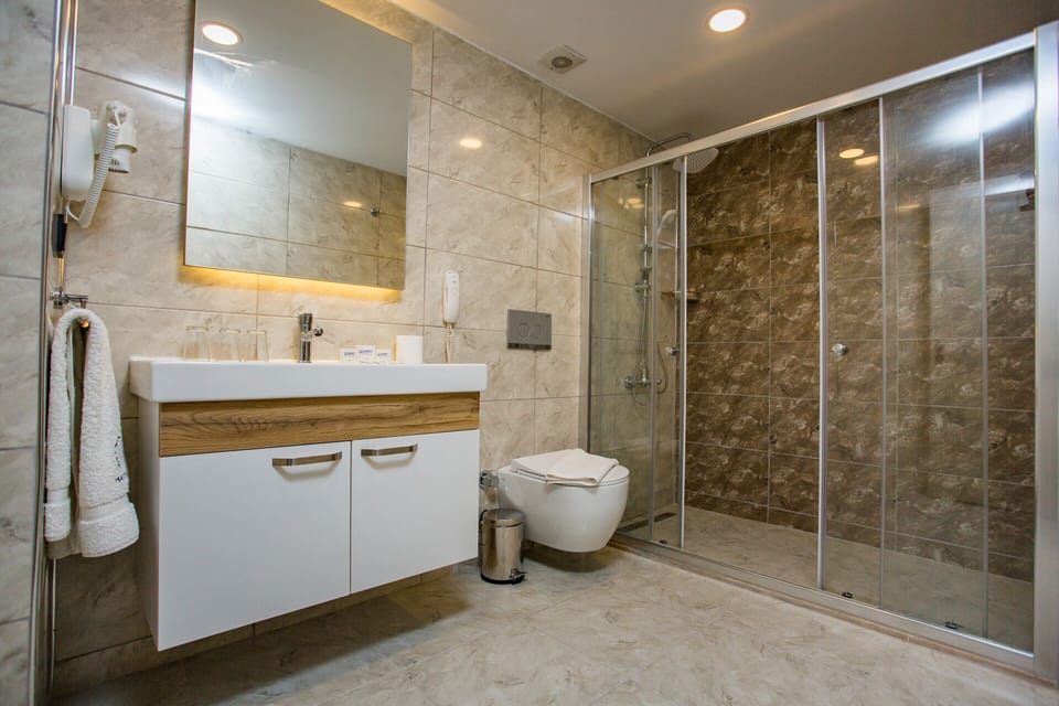 Shower, hair dryer, slippers, towels