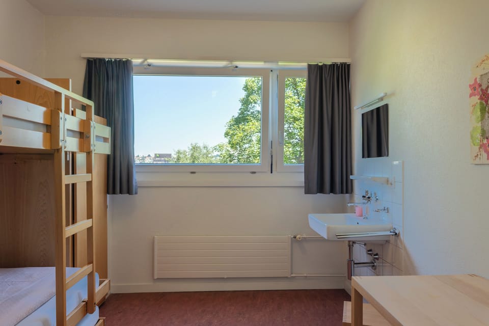 Desk, iron/ironing board, bed sheets