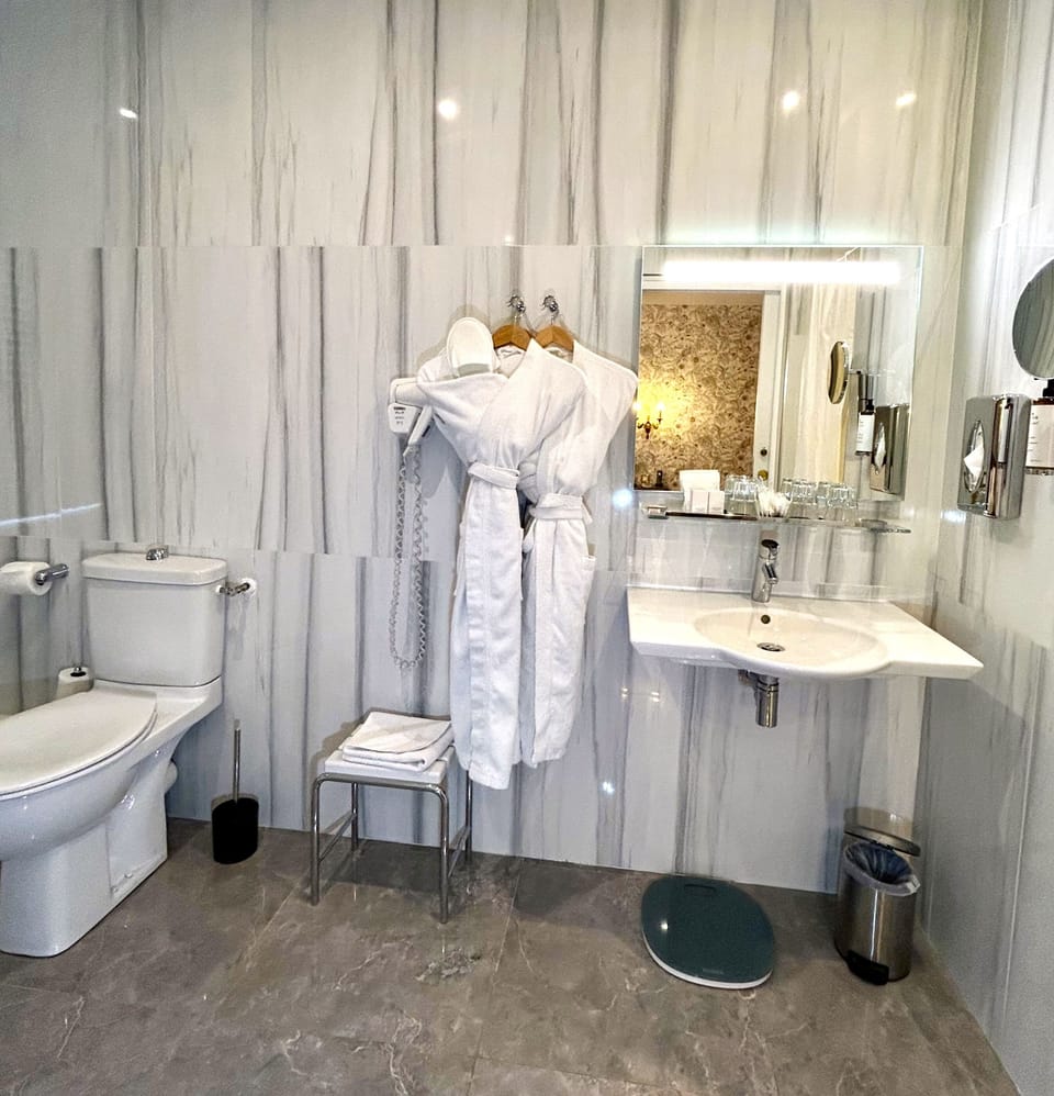 Suite | Bathroom | Hair dryer, bathrobes, slippers, towels