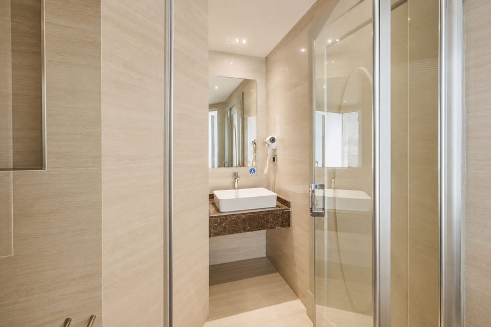 Suite, 1 King Bed, Corner | Bathroom | Shower, designer toiletries, hair dryer, bathrobes