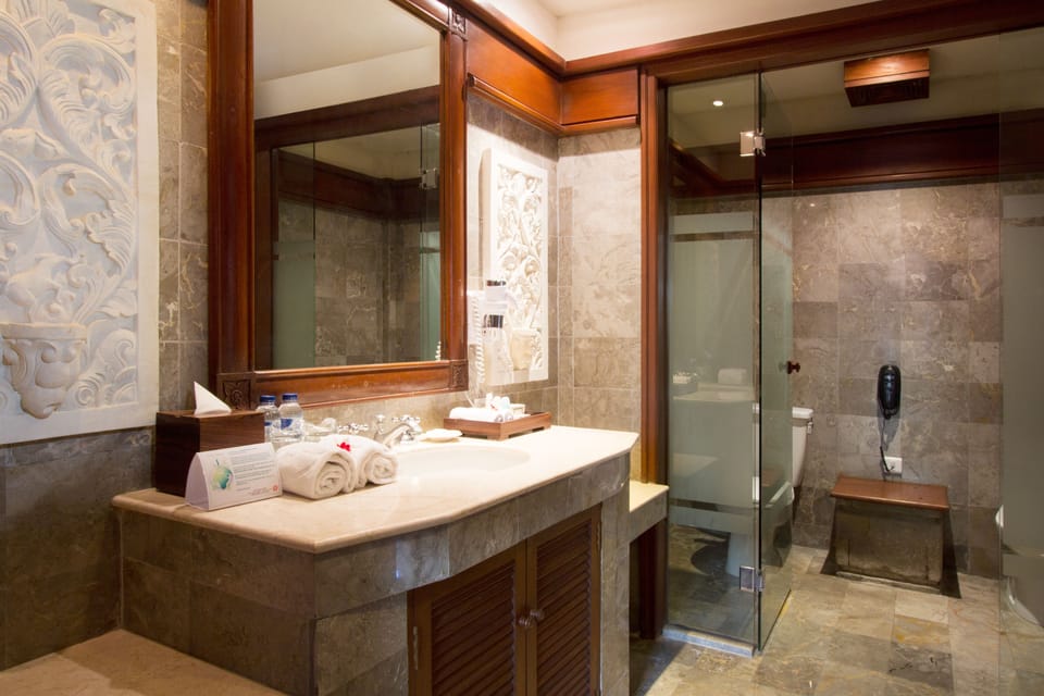 Garden Suite | Bathroom | Separate tub and shower, rainfall showerhead, eco-friendly toiletries