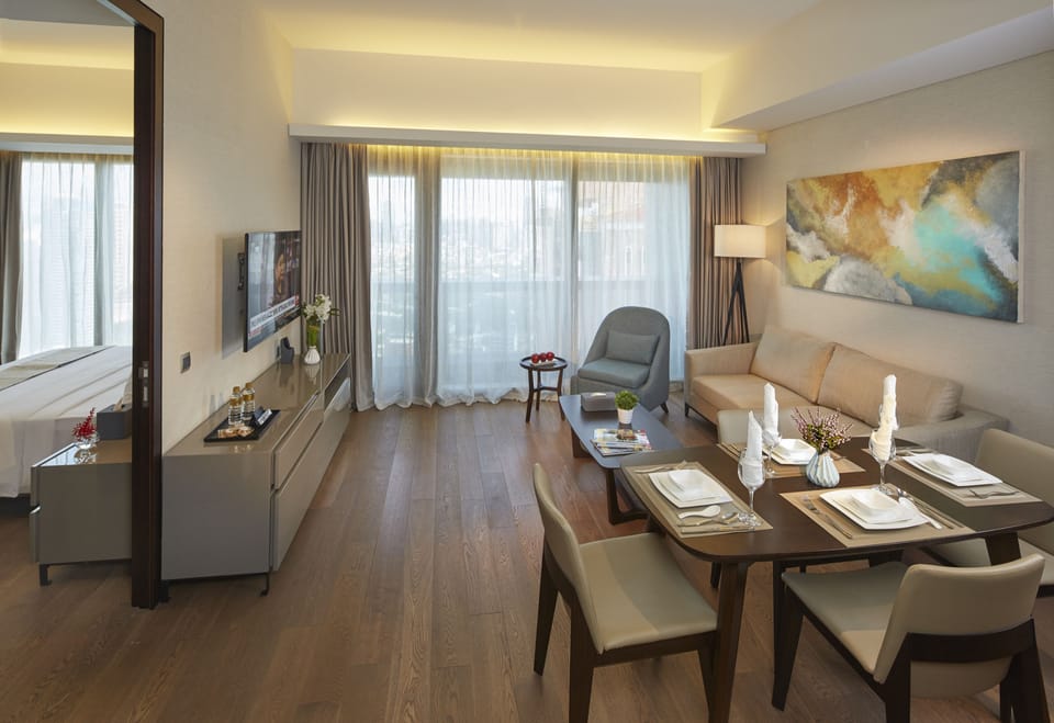 Junior Suite, 2 Bedrooms | Living area | 49-inch LED TV with cable channels, TV