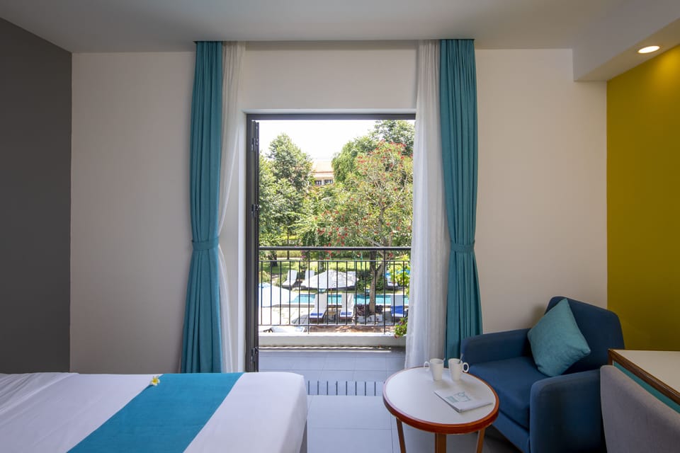 Deluxe Double Room, Balcony, Pool View | Minibar, in-room safe, desk, blackout drapes