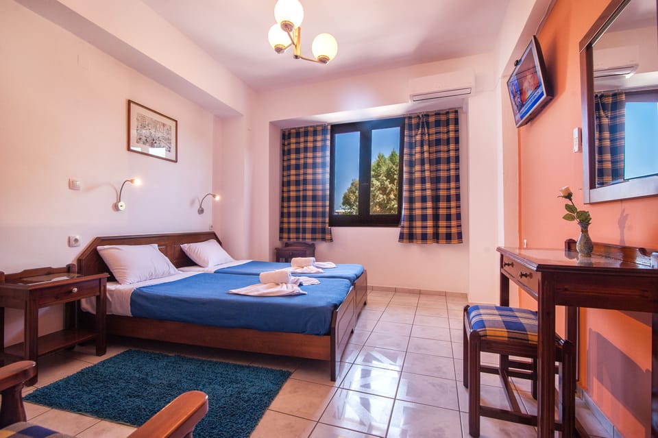 Triple Room, City View | In-room safe, desk, laptop workspace, iron/ironing board