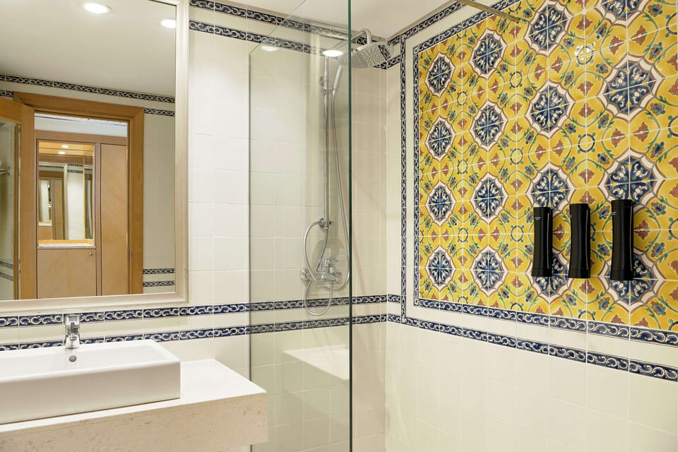 Shower, rainfall showerhead, hair dryer, towels