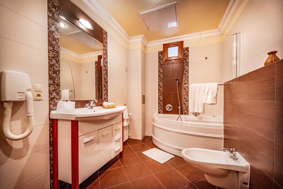 Jetted tub, designer toiletries, hair dryer, towels