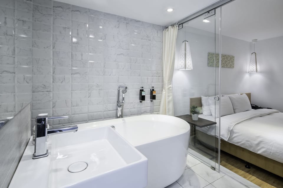 Grand Double Room, Bathtub | Bathroom | Hair dryer, slippers, towels