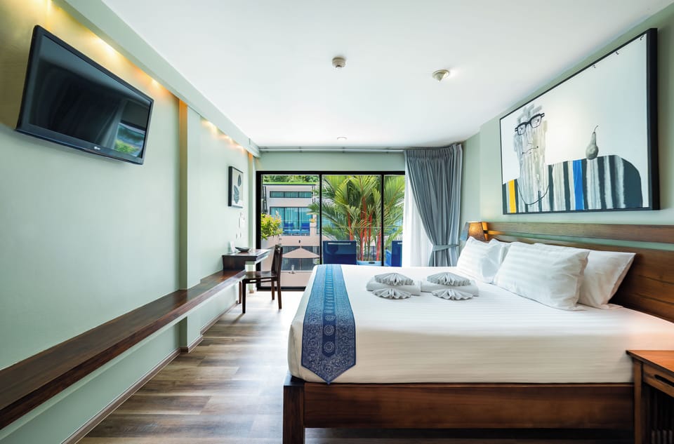 Deluxe Double Room, Pool View | Minibar, in-room safe, desk, laptop workspace