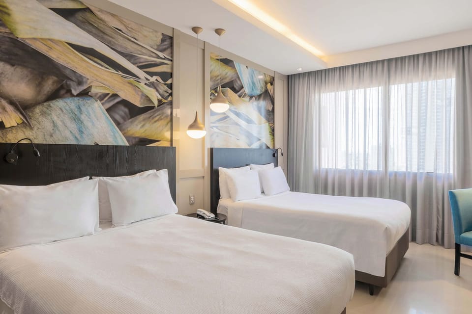 Luxury Twin Room | Minibar, in-room safe, desk, blackout drapes