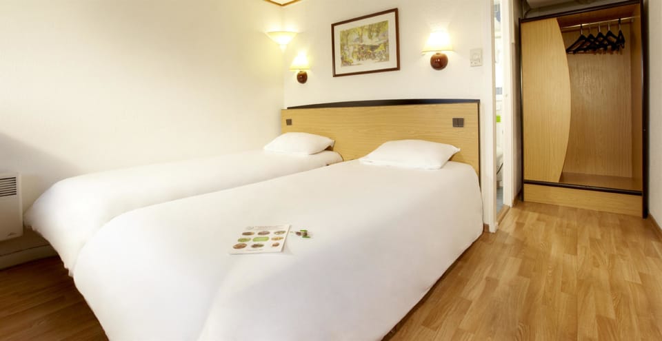 Premium bedding, desk, laptop workspace, blackout drapes
