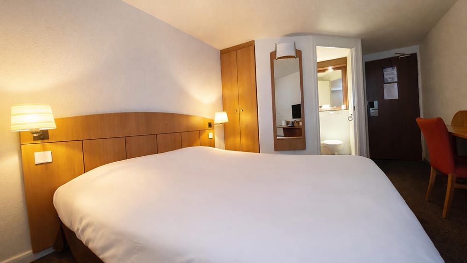 Premium bedding, desk, laptop workspace, blackout drapes