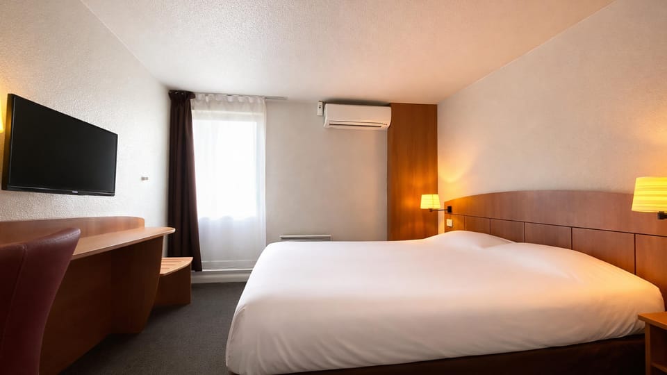 Premium bedding, desk, laptop workspace, blackout drapes