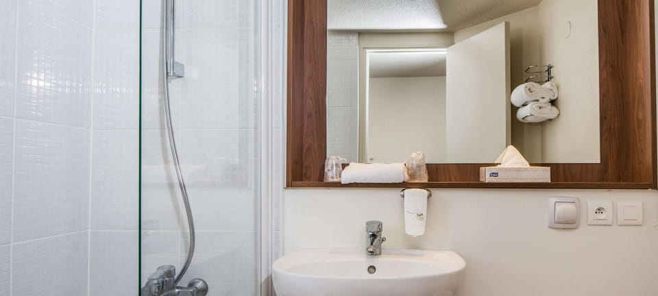 Premium bedding, desk, laptop workspace, blackout drapes