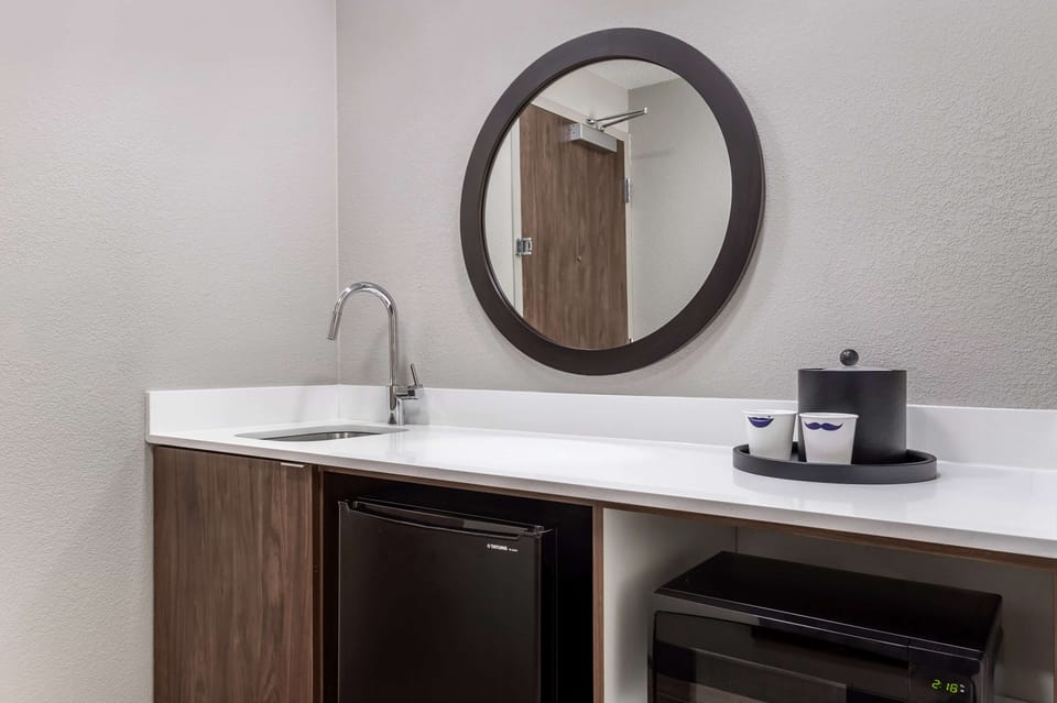 Desk, laptop workspace, blackout drapes, iron/ironing board