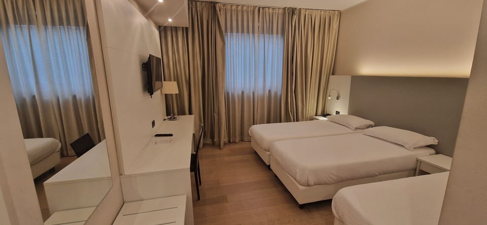 Standard Triple Room | Minibar, in-room safe, desk, soundproofing