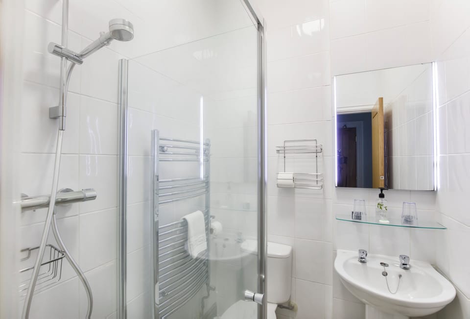 Shower, hair dryer, towels, toilet paper