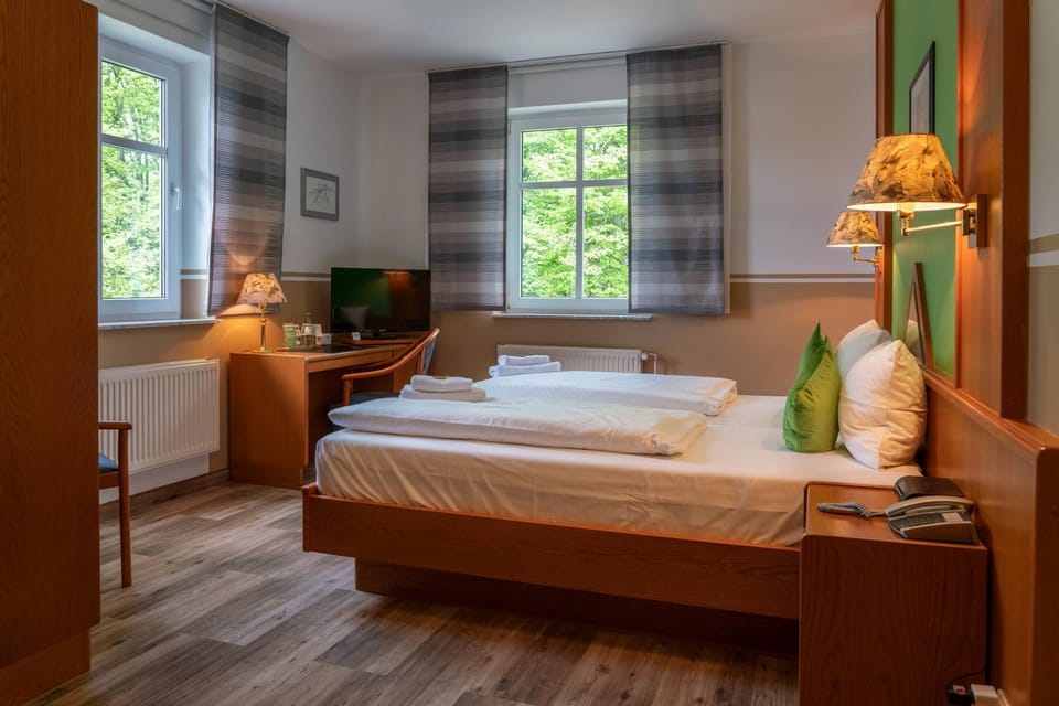 Premium bedding, desk, laptop workspace, blackout drapes