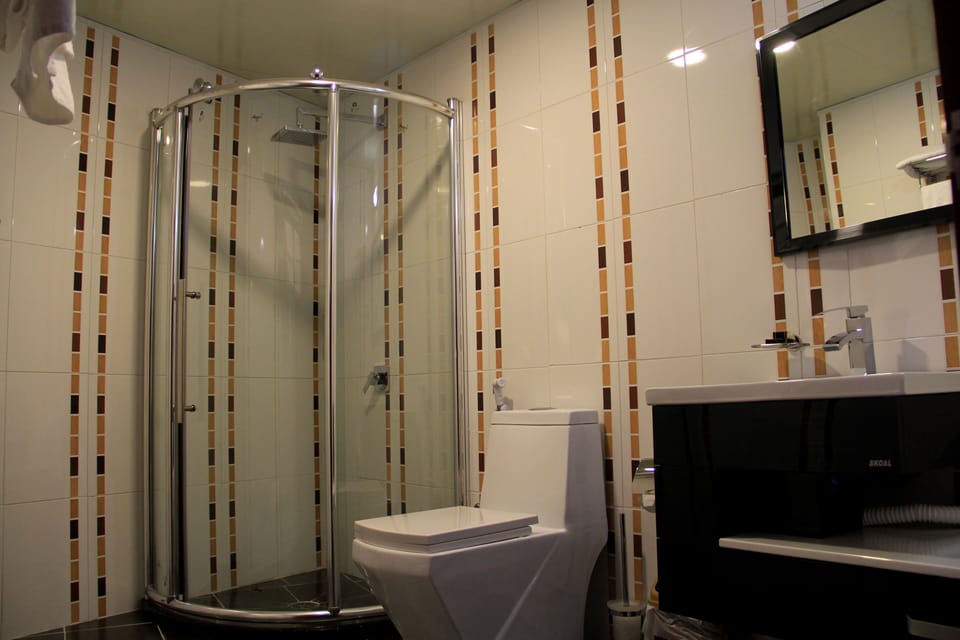 Triple Room, City View | Bathroom | Shower, free toiletries, hair dryer, slippers