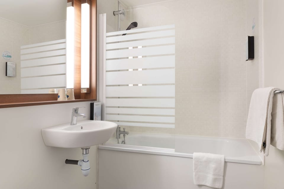 Premium bedding, desk, laptop workspace, blackout drapes