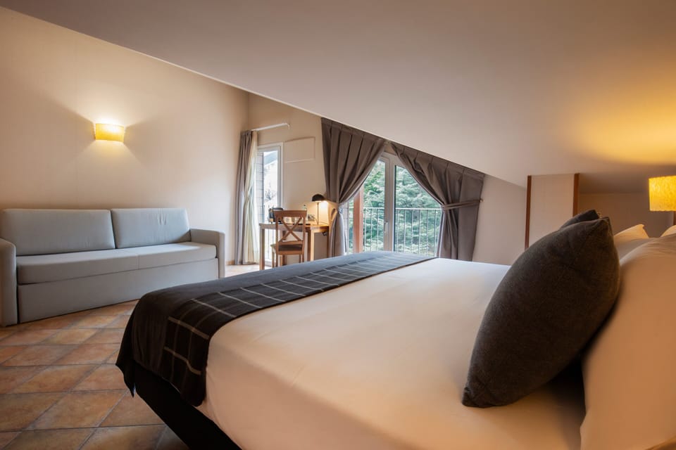 Superior Quadruple Room | Minibar, in-room safe, desk, laptop workspace