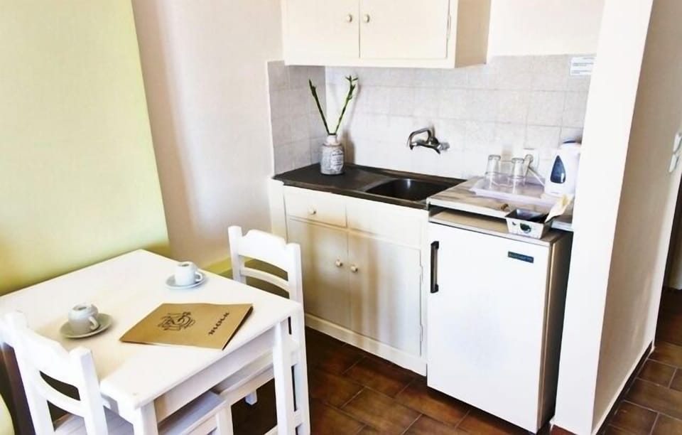 Triple Room, Garden View | Private kitchenette | Fridge, electric kettle