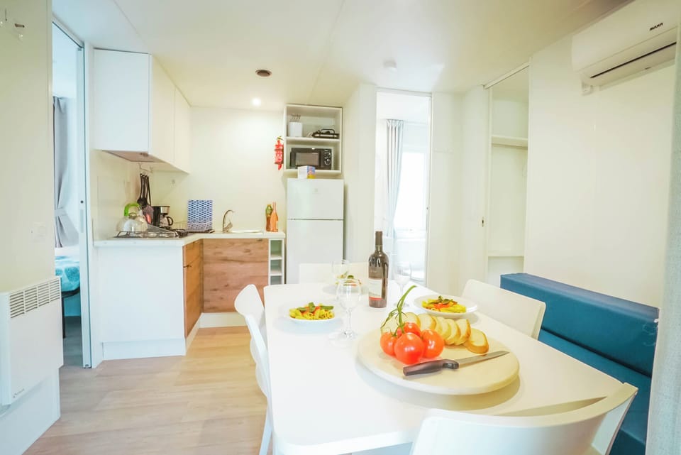 Superior Mobile Home | Private kitchen | Full-size fridge, stovetop, cookware/dishes/utensils, dining tables