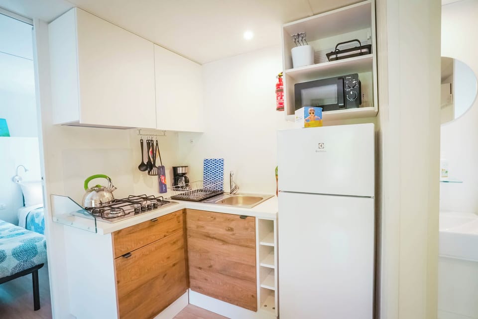 Superior Mobile Home | Private kitchen | Full-size fridge, stovetop, cookware/dishes/utensils, dining tables