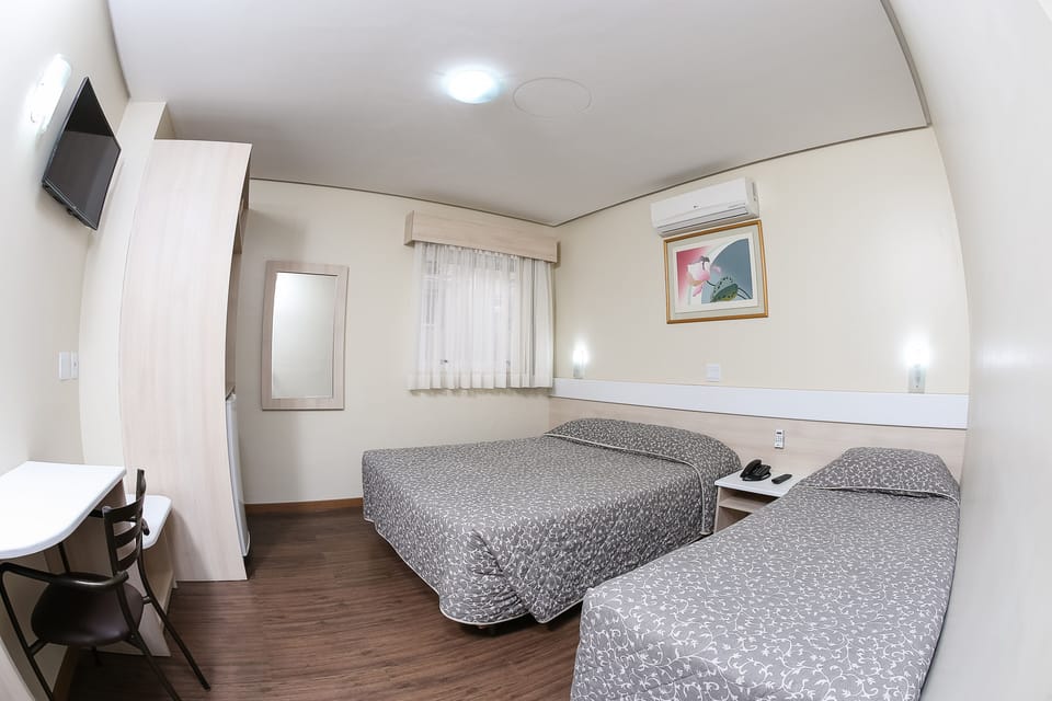 Family Triple Room | Minibar, in-room safe, desk, blackout drapes