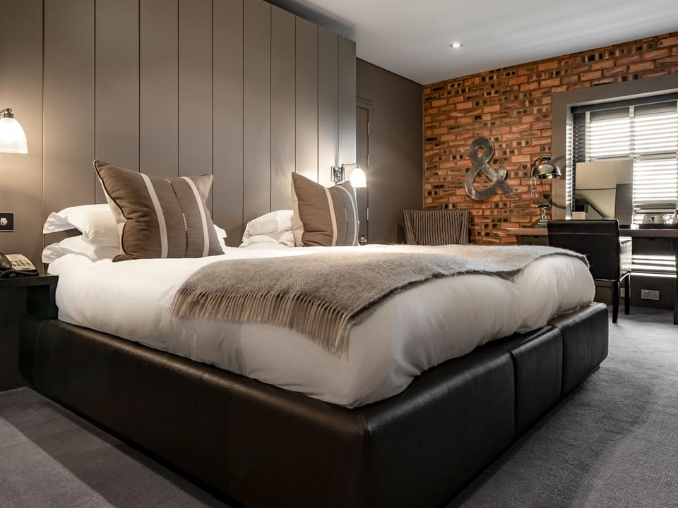 Premium bedding, desk, laptop workspace, iron/ironing board