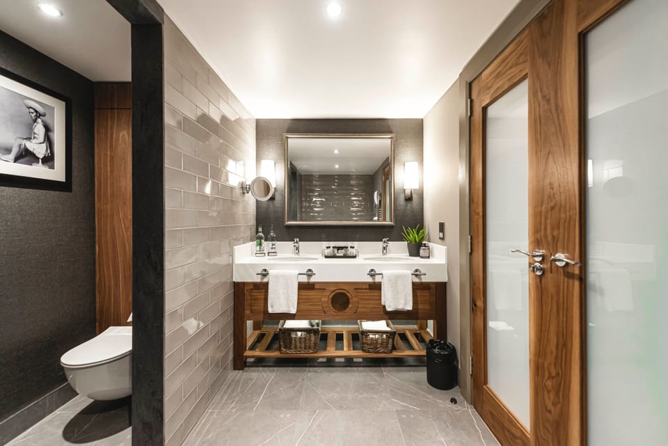 Deluxe Suite | Bathroom | Designer toiletries, hair dryer, towels, soap