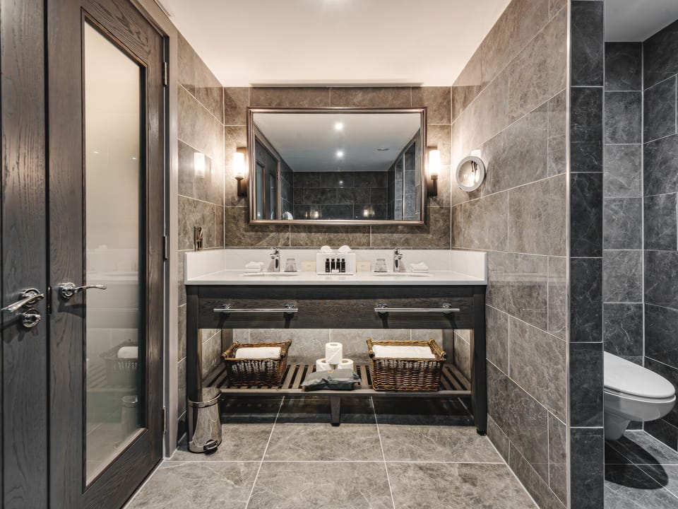 Deluxe Suite | Bathroom | Designer toiletries, hair dryer, towels, soap
