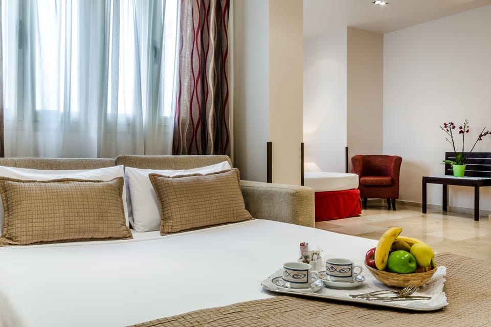 Family Room | Down comforters, minibar, in-room safe, individually furnished