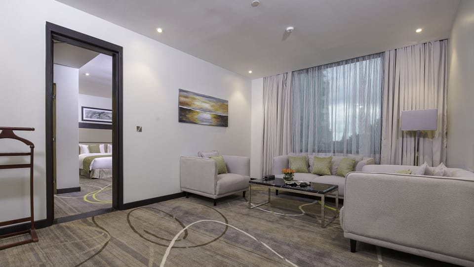 Suite, 1 King Bed | Living area | 43-inch LCD TV with cable channels, TV