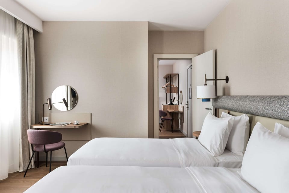Twin Room | Down comforters, minibar, in-room safe, individually decorated