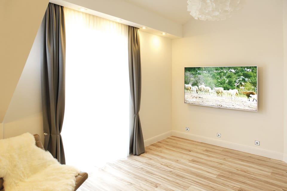 Grand Suite, Balcony with garden view | Living room | 55-inch flat-screen TV with cable channels, TV