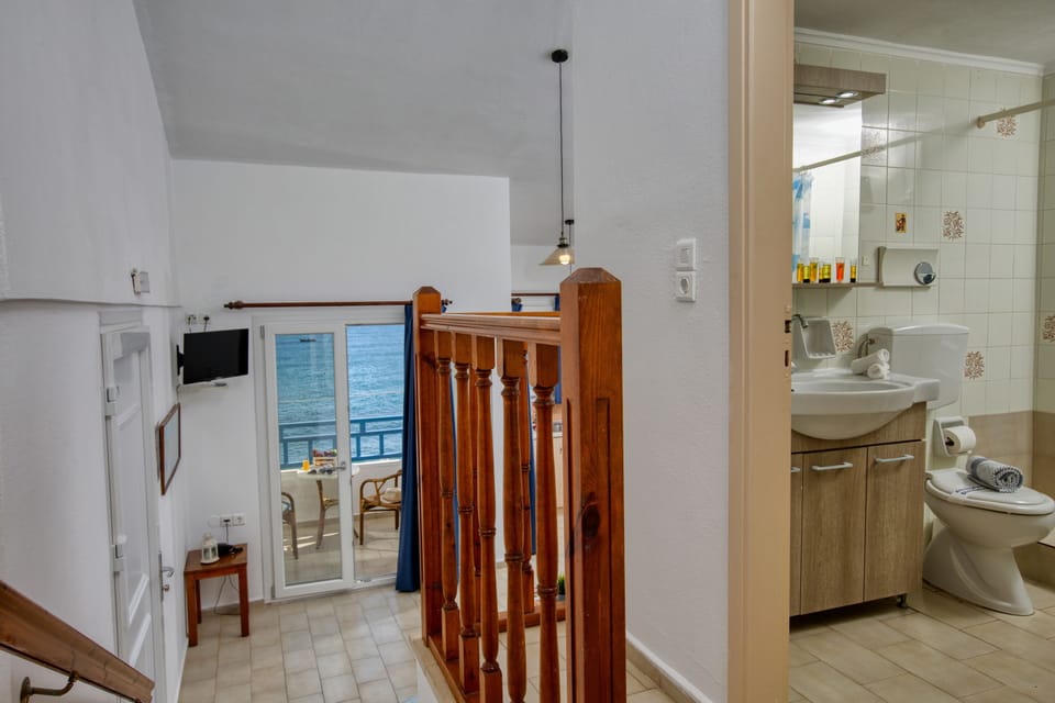 Apartment, 1 Bedroom, Sea View | 1 bedroom, blackout drapes, iron/ironing board, free WiFi