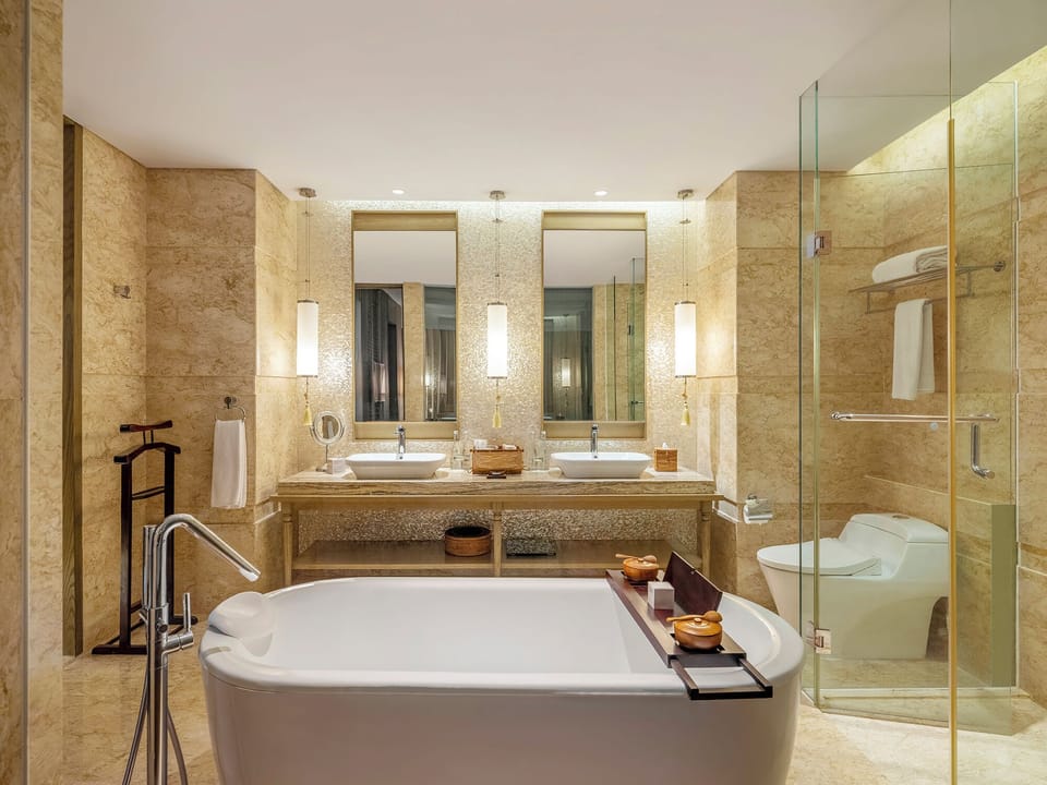 Premium Suite, 1 King Bed | Bathroom | Separate tub and shower, rainfall showerhead, eco-friendly toiletries