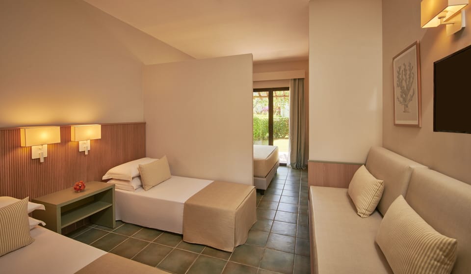 Family Room, Garden View | In-room safe, desk, laptop workspace, bed sheets