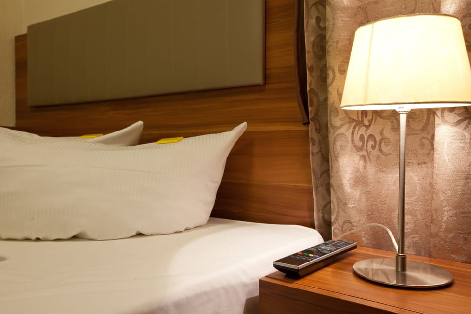 Hypo-allergenic bedding, desk, laptop workspace, blackout drapes